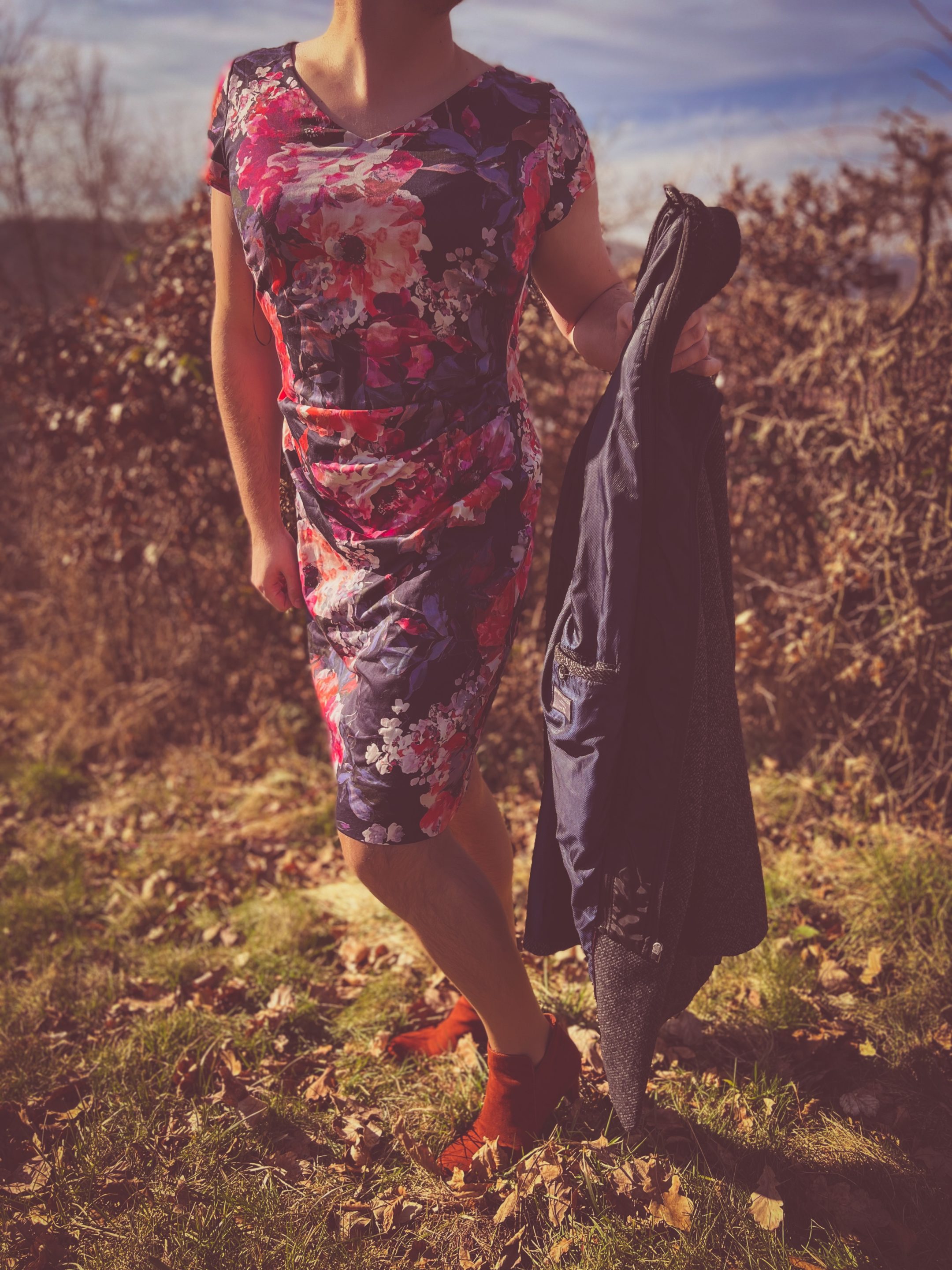 Man in a flowing cocktail dress, showing off the full look