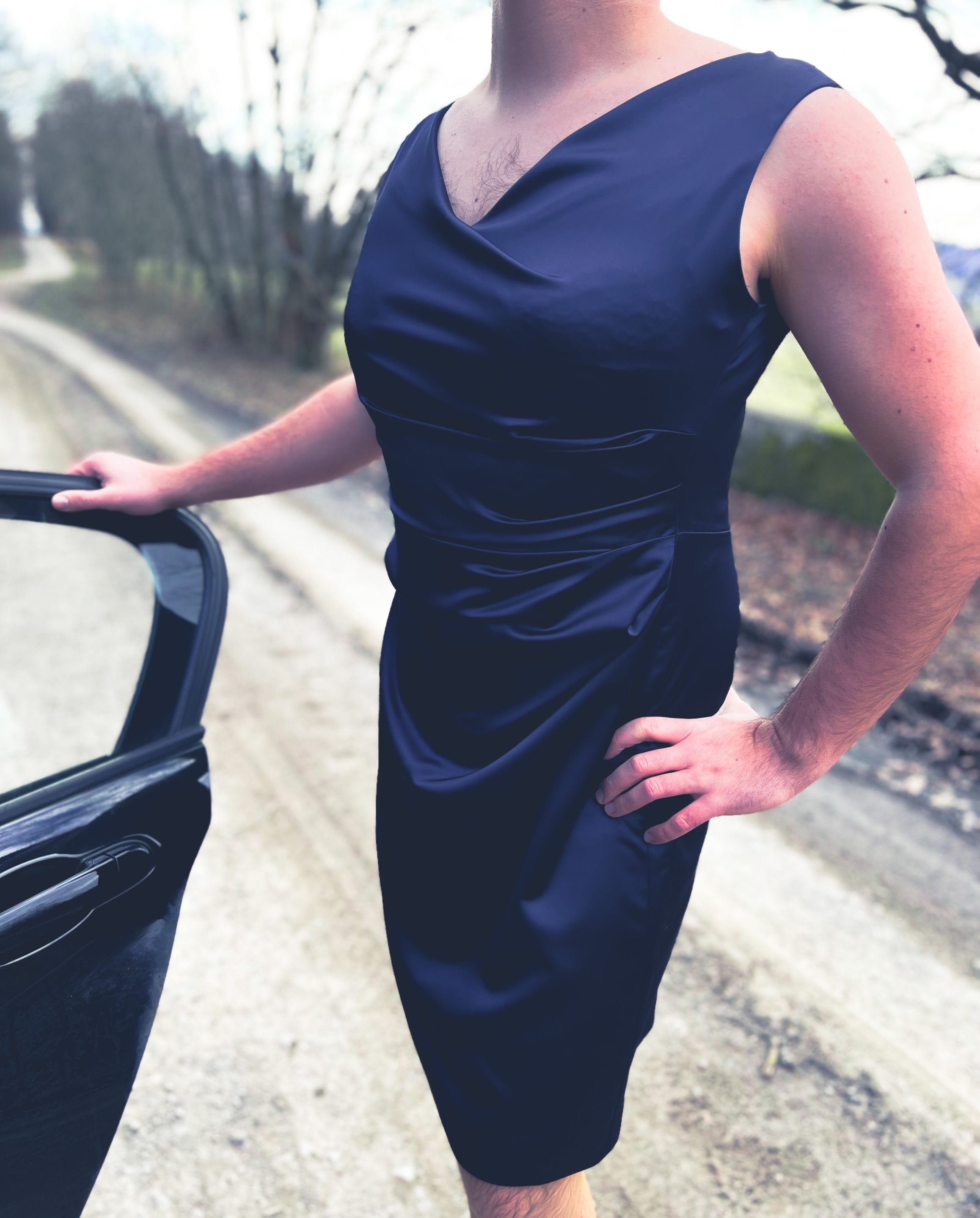 Man posing in a cocktail dress for an outdoor photo shoot