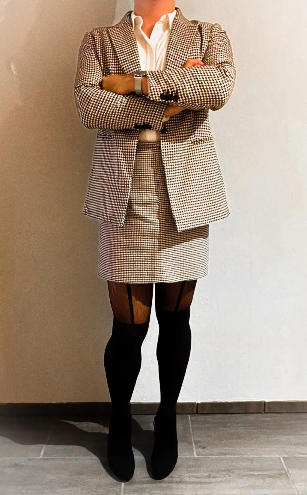 Man wearing a skirt, blazer, and blouse on the way to the office