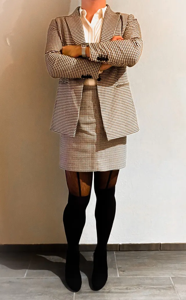 Man wearing a skirt, blazer, and blouse on the way to the office